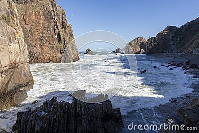 Amazing view of grassy rocky cliffs by the cantabrian sea with violent waves, asturias, spain - Asturian concept Stock Photo