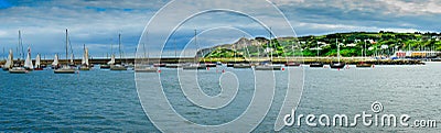 Amazing view at Howth marina bay near Dublin, Ireland with yachts and boats. green mountains in the background Stock Photo