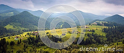 Amazing view of the mountain village Dzembronya foggy morning in the mountains in summer. Stock Photo