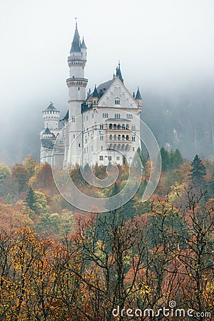 Amazing view of Neuschwanstein castle in autumn season at fog. Bavaria. Germany. Neuschwanstein castle one of the most popular pal Stock Photo