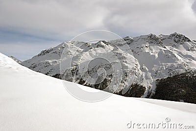 An amazing view of snow covered landscape and ski lift and a piste in the alps switzerland in winter Stock Photo