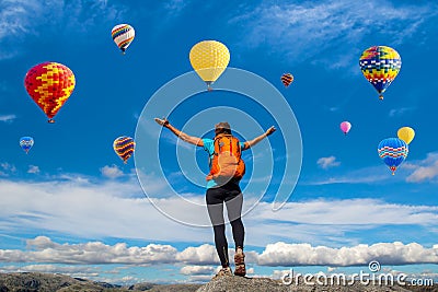 Amazing view with sport girl and a lot of hot air balloons. Artistic picture. Beauty world. The feeling of complete freedom Stock Photo