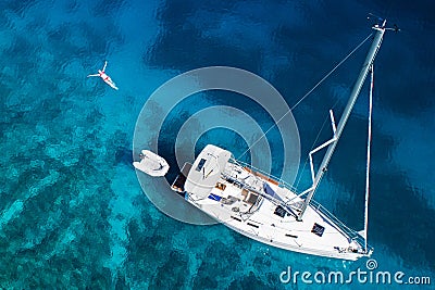 Amazing view to yacht, swimming woman and clear water in caribbean paradise Stock Photo