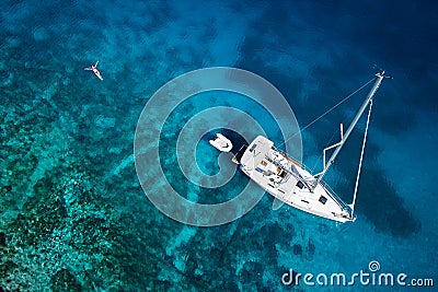 Amazing view to yacht, swimming woman and clear water caribbean Editorial Stock Photo