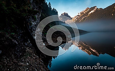 Amazing water reflection in clear moutain lake during sunrise morning switzerland Stock Photo