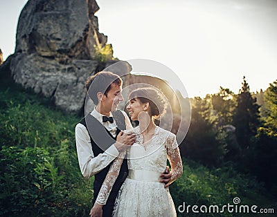 Luxury wedding couple is hugging each other in mountains Stock Photo