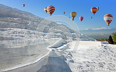 Hot air ballons flying above white Pamukkale, Turkey Stock Photo