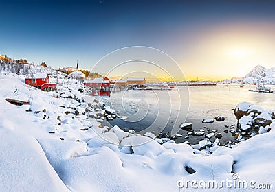 Amazing winter scenery of Moskenes village with ferryport and famous Moskenes parish Churc Stock Photo