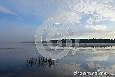 Amazingly beautiful early summer morning on the river, clouds reflected in the water surface Stock Photo