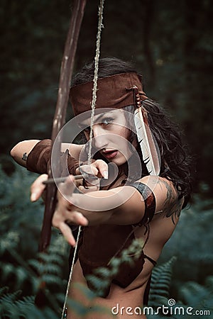 Amazon huntress aiming with bow Stock Photo