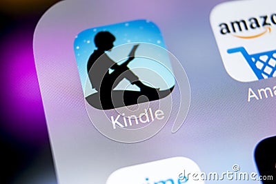 Amazon Kindle application icon on Apple iPhone X screen close-up. Amazon Kindle app icon. Amazon kindle application. Social media Editorial Stock Photo