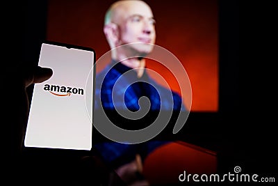 Amazon logo on screen and Jeff Bezos is a Executive Chairman of Amazon in background Editorial Stock Photo