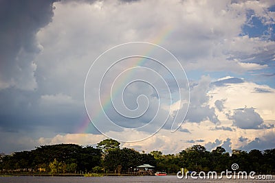 Amazon river jungle rainbow and clouds Stock Photo