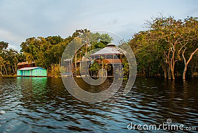 Amazon river, Manaus, Amazonas, Brazil: Amazon landscape with beautiful views. Wooden houses on an island on the Amazon river in Stock Photo