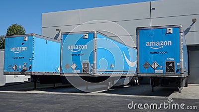 Amazon trucks parked at loading dock at regional fulfillment center. Photo taken in Carlsbad, CA / USA - April 15, 2020. Editorial Stock Photo
