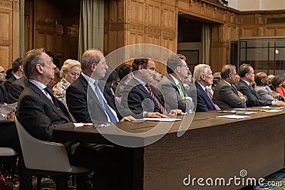 Ambassadors big hall desk sitting tlking ICJ peace palace the hague in line row Editorial Stock Photo