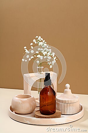 Amber glass spray cosmetic bottle and modern DIY concrete home decor on beige background Stock Photo