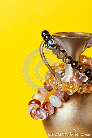 Amber semiprecious bracelet on yellow background Stock Photo