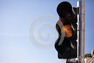 Amber, yellow traffic lights for cars, blue sky background Stock Photo