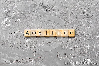 Ambition word written on wood block. ambition text on cement table for your desing, concept Stock Photo