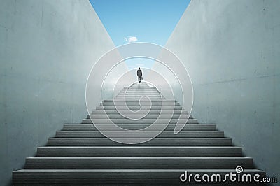 Ambitions concept with businessman climbing stairs Stock Photo