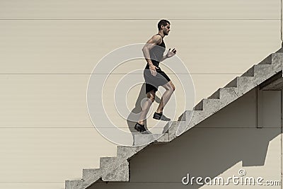 Ambitions concept with sportsman climbing stairs Stock Photo