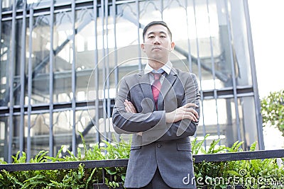 Ambitious Asian Business Person Standing Stock Photo