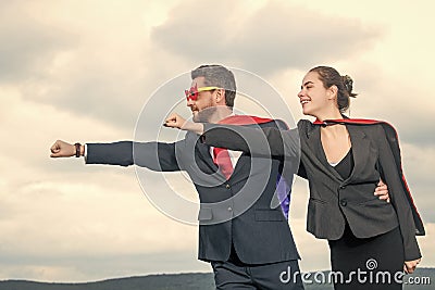 ambitious business couple in superhero suit on sky background Stock Photo