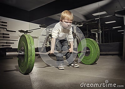 Ambitious, Determined little boy trying to lift Stock Photo