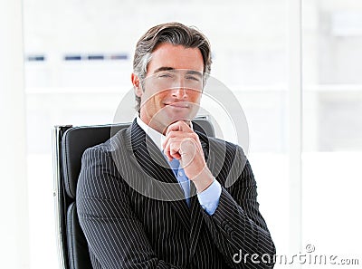 Ambitious male executive sitting in his office Stock Photo