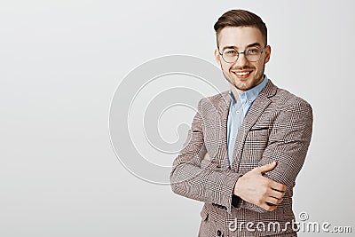 Ambitious smart and intelligent good-looking european male entrepreneur in glasses and stylish jacket crossing hands on Stock Photo