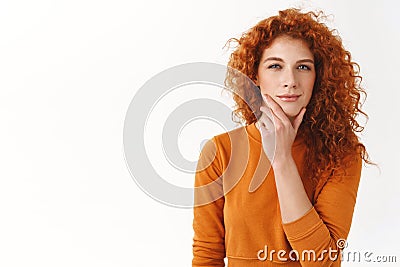 Ambitious thoughtful female redhead entrepreneur rub chin, squinting as thinking making interesting assumption, have Stock Photo