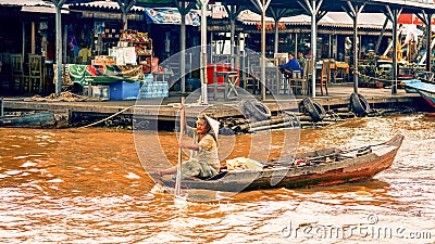 Ambodian people live on Tonle Sap Lake in Siem Reap, Cambodia. Old woman rowing a boat Editorial Stock Photo