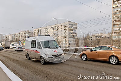 Ambulance based on a Mercedes van in a hurry to call on the cleared snow from the bridge Editorial Stock Photo