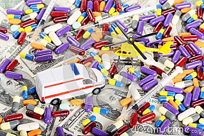Ambulance car and helicopter toys through pills and dollars Stock Photo
