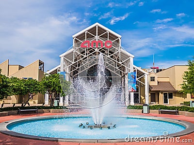 AMC DINE-IN Disney Springs 24 featuring a large fountain in the foreground Editorial Stock Photo