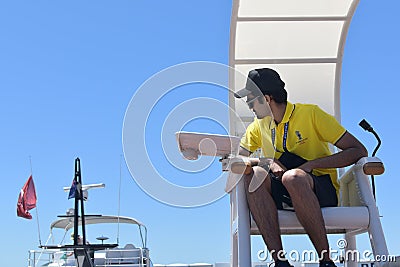 America's Cup volunteer in yellow jersey sitting on umpire chair Editorial Stock Photo