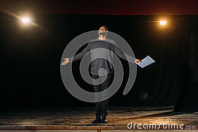 American actor holding scenario and standing Stock Photo