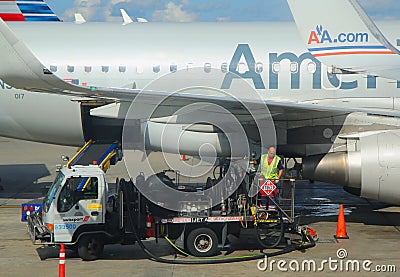 American Airlines worker refueling plane at Miami International Airport Editorial Stock Photo