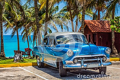 American blue Chevrolet classic car with silver roof parked on the beach in Varadero Cuba - Serie Cuba Reportage Stock Photo