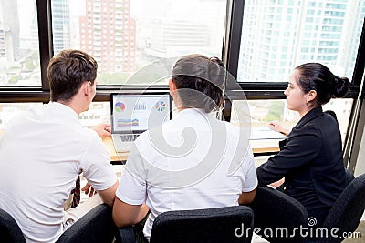 American business team having using laptop during a meeting and presents. Stock Photo