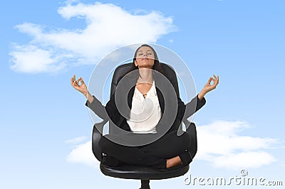 American business woman sitting at office chair in lotus posture practicing yoga and meditation Stock Photo