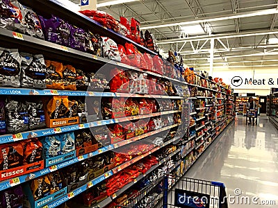 American candy sweets chocolate displayed at shelves of a Walmart in Orlando Florida in warm lighting Editorial Stock Photo