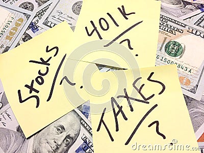 American cash money with text Stocks and 401K and Taxes with question marks Stock Photo