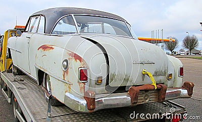 1951 American Chrysler Newport car on a recovery truck being taken for restoration Editorial Stock Photo