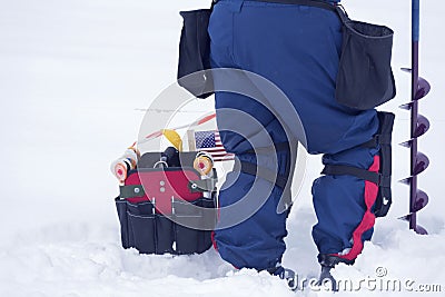 American competitor in XVI World Ice fishing championship on the frozen water with his equipment. Stock Photo