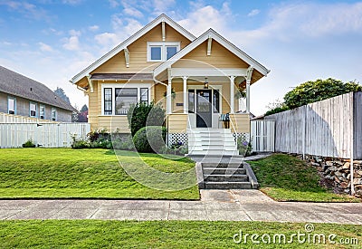 American craftsman home with yellow exterior paint. Stock Photo