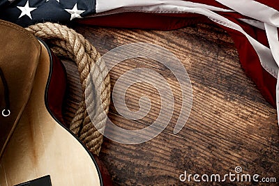 American culture, living on a ranch and country muisc concept theme with a cowboy hat, USA flag, rope lasso and acoustic guitar on Stock Photo