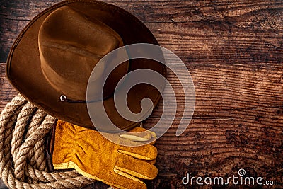 American culture, living on a ranch or farm and country muisc concept theme with a cowboy hat, rope lasso and rodeo leather gloves Stock Photo