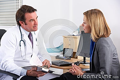 American doctor talking to businesswoman patient Stock Photo